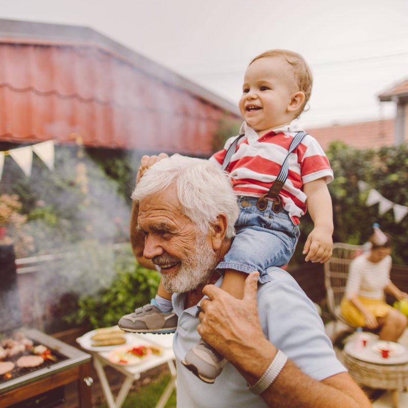 With grandfather at the barbecue party Photo of grandfather and grandson at the barbecue party