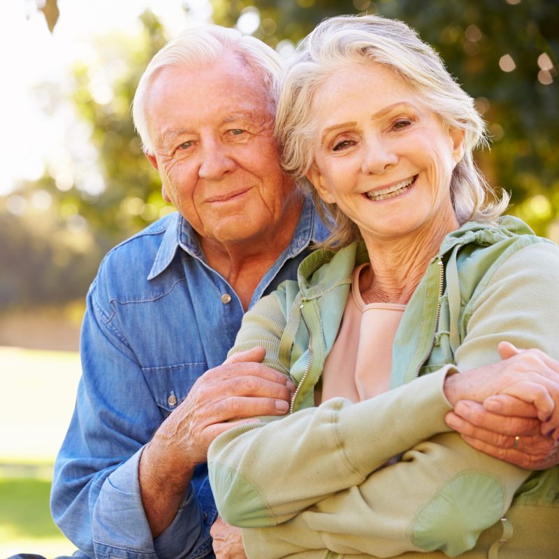 Outdoor Portrait Of Loving Senior Couple Outdoor Portrait Of Loving Senior Couple Smiling To Camera