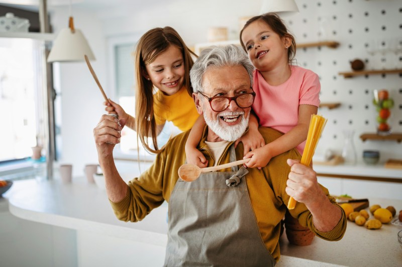 Christian grandfather lifting his young grand kids in the air, representing a charitable lead trust used to fund ministry now and transfer assets to grandchildren later