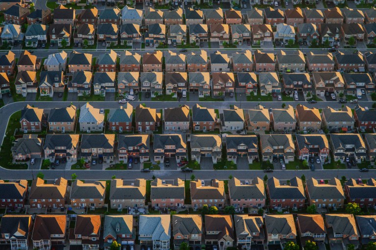 Aerial view of a suburban housing development with rows of single-family homes