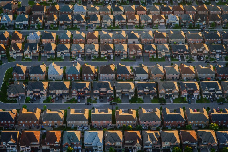 Aerial view of a suburban housing development with rows of single-family homes